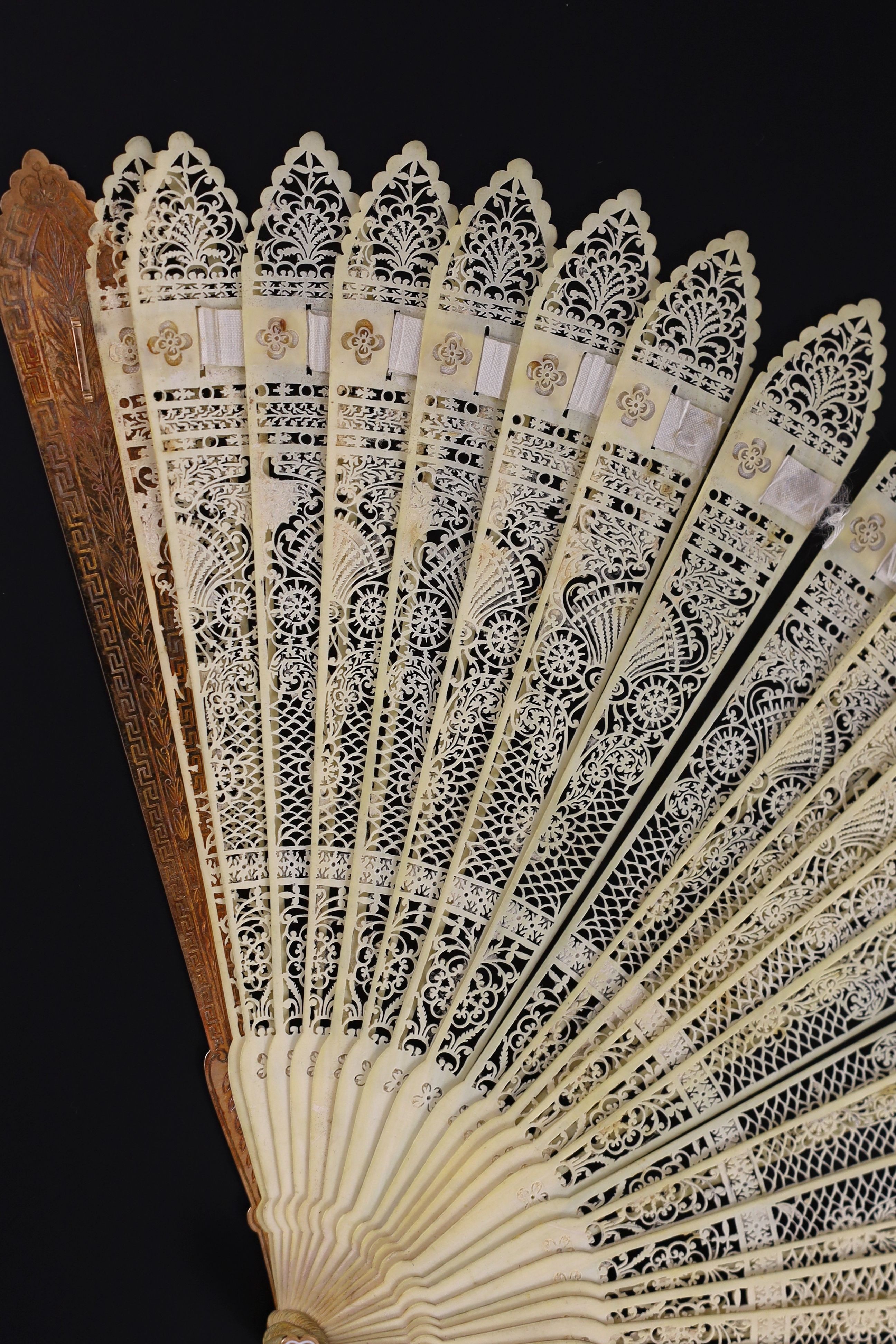 A German or Swiss gold, enamel and ivory brise fan, 19th century, possibly made for the Ottoman market, 17.3 cm closed, slight losses to sticks, needs rethreading